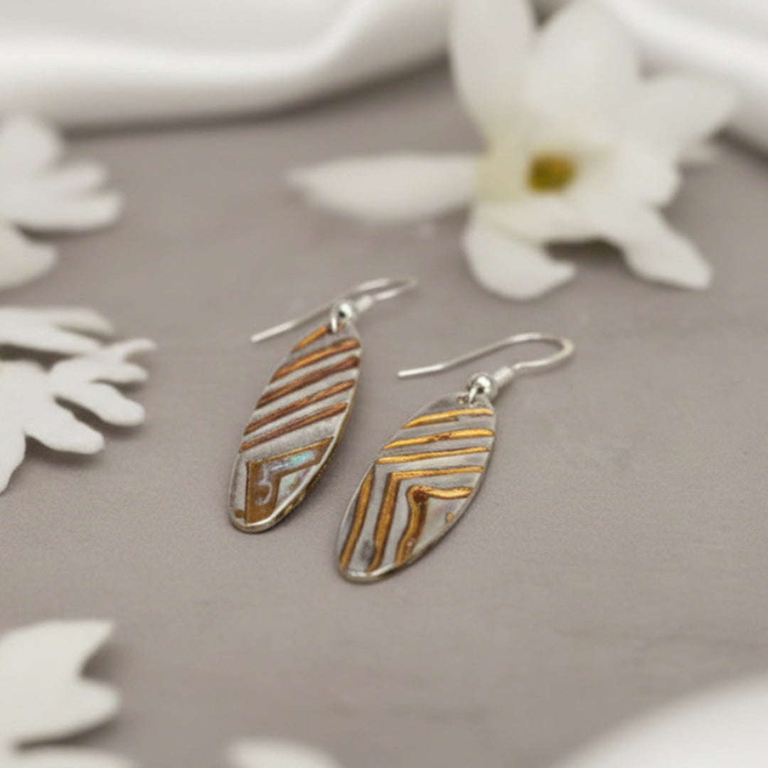 Pair of long oval shaped earrings with oxidized chevron pattern by Arlana Exquisite Styles.