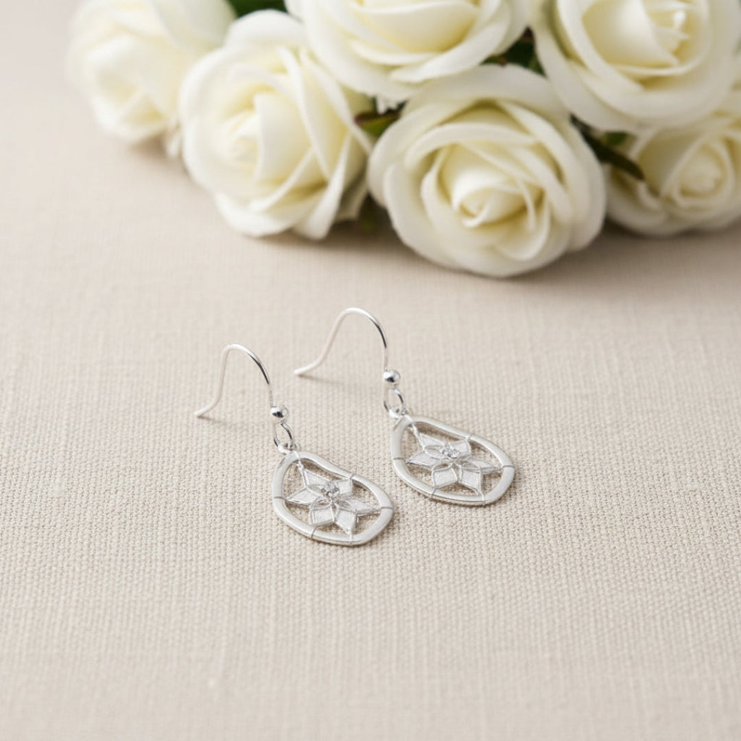 A set of sterling silver earrings designed in a shape of a teardrop. The earrings are dreamcatchers. Arlana Exquisite Styles.