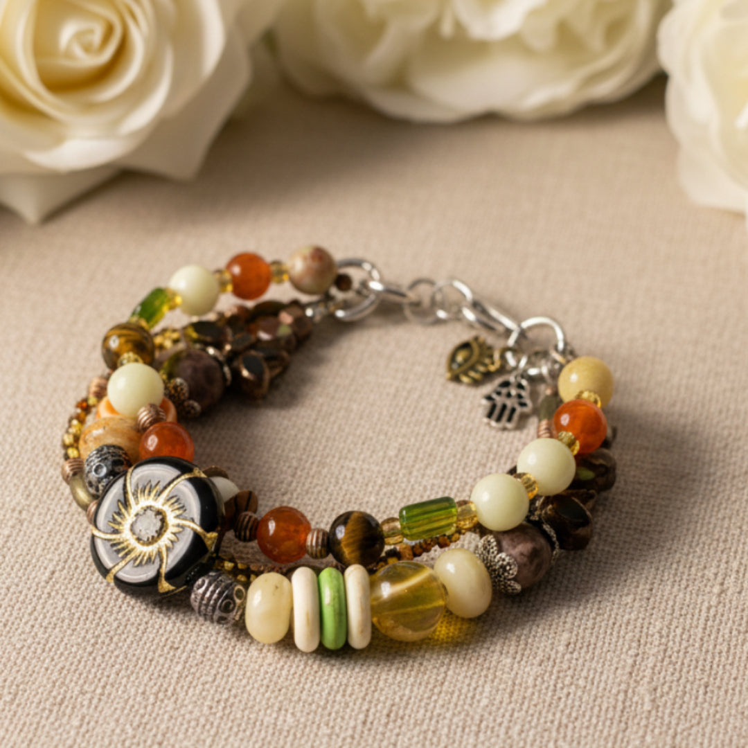 Multicolored beaded bracelet with various charms on a textured background