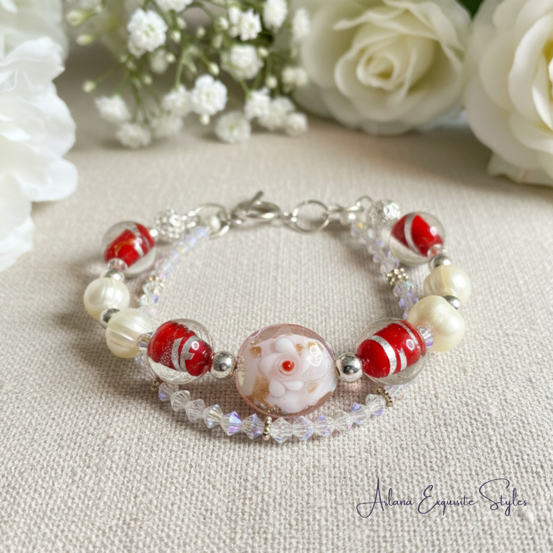 Beaded bracelet with red and white beads on a light fabric background with flowers.