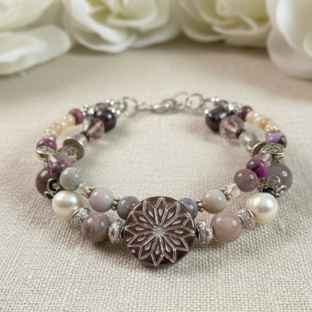 Stylish beaded bracelet with decorative elements on a textured surface