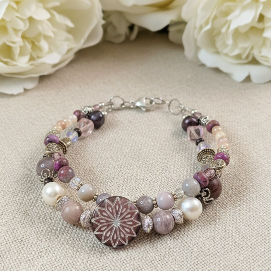 Beaded bracelet with a decorative clasp on a textured surface