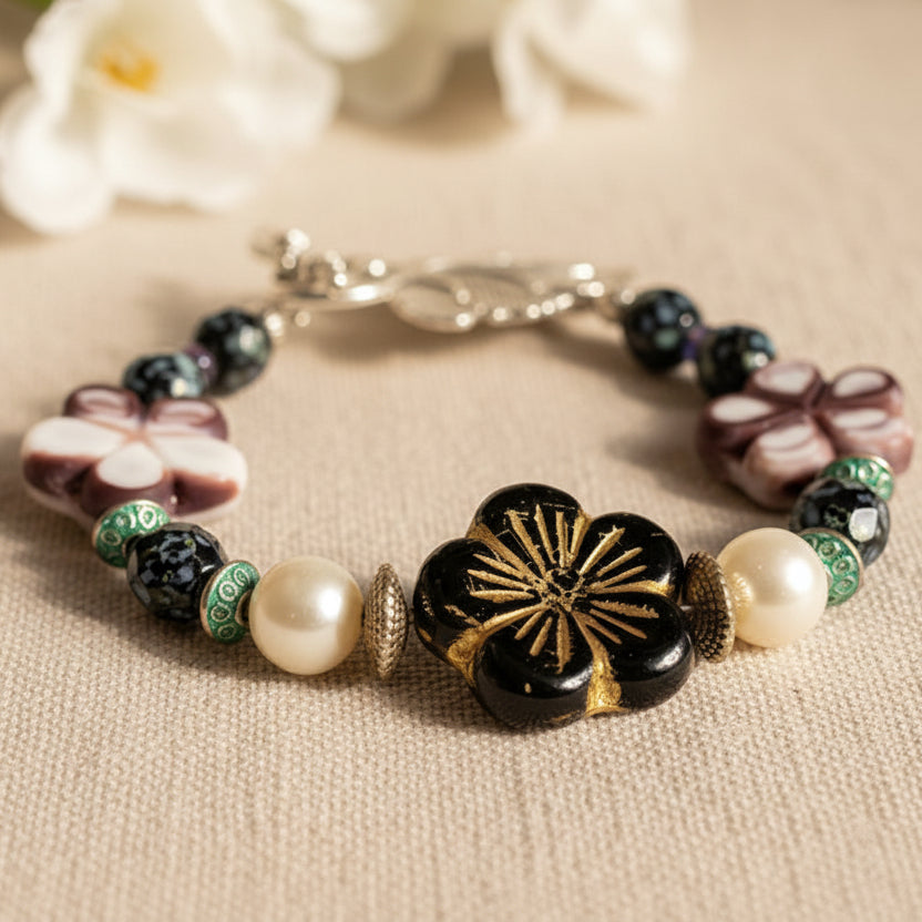 Multicolored beaded bracelet with floral and leaf designs.