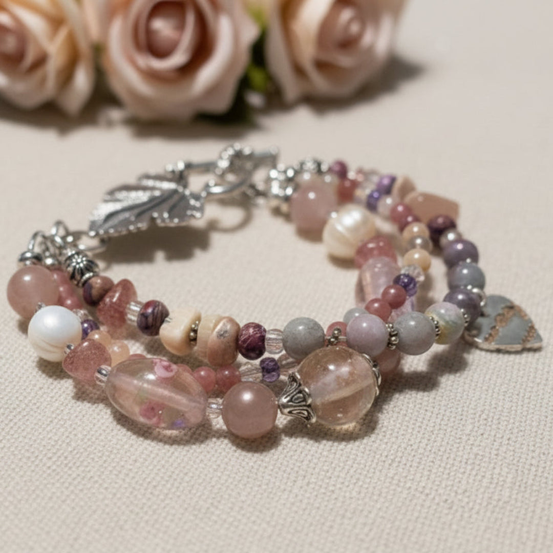 Beaded bracelet with leaf charm on a beige surface