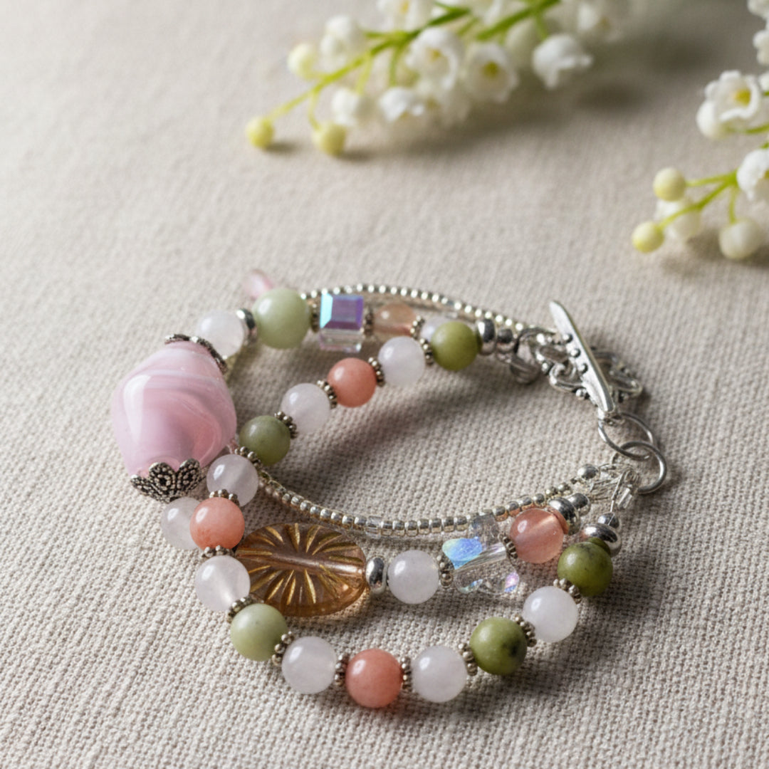 Beaded bracelet with colorful beads and a metal clasp on a light green background.  Handmade in Canada by Arlie Quinn of Arlana Exquisite Styles.